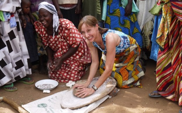 women in Uganda preparing dough