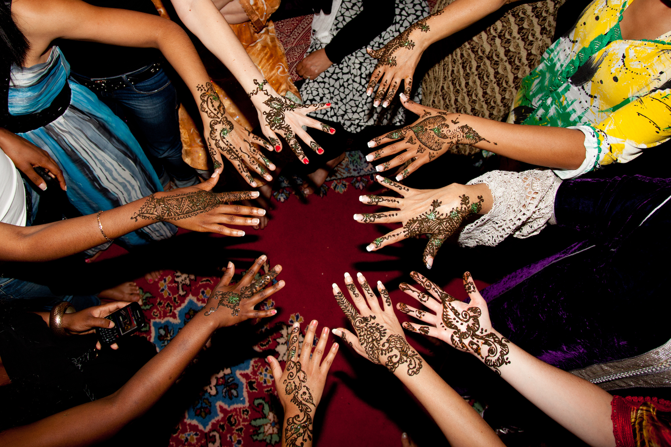 circle of hands with hena