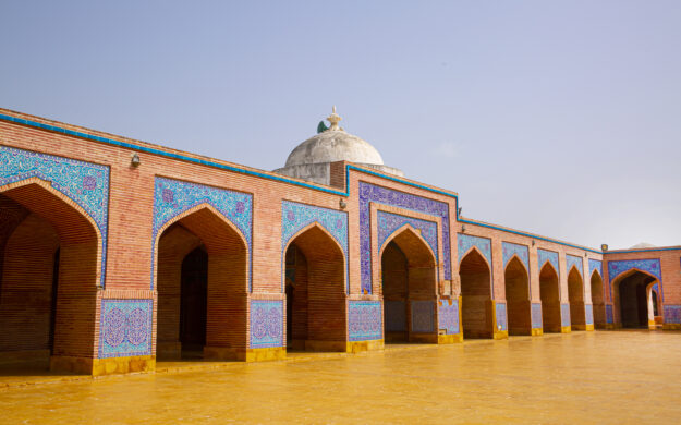 Shah Jahan Mosque in Thatta, Pakistan. Beautiful architecture, yellow, blue and orange colors.