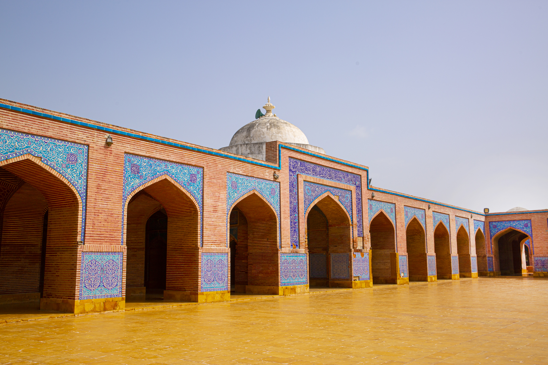 Shah Jahan Mosque in Thatta, Pakistan. Beautiful architecture, yellow, blue and orange colors.