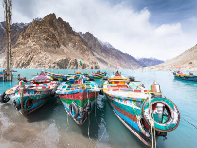 Local gondola boat wooden with Natural view along Attabad lake in Pakistan mountains at Hunza valley