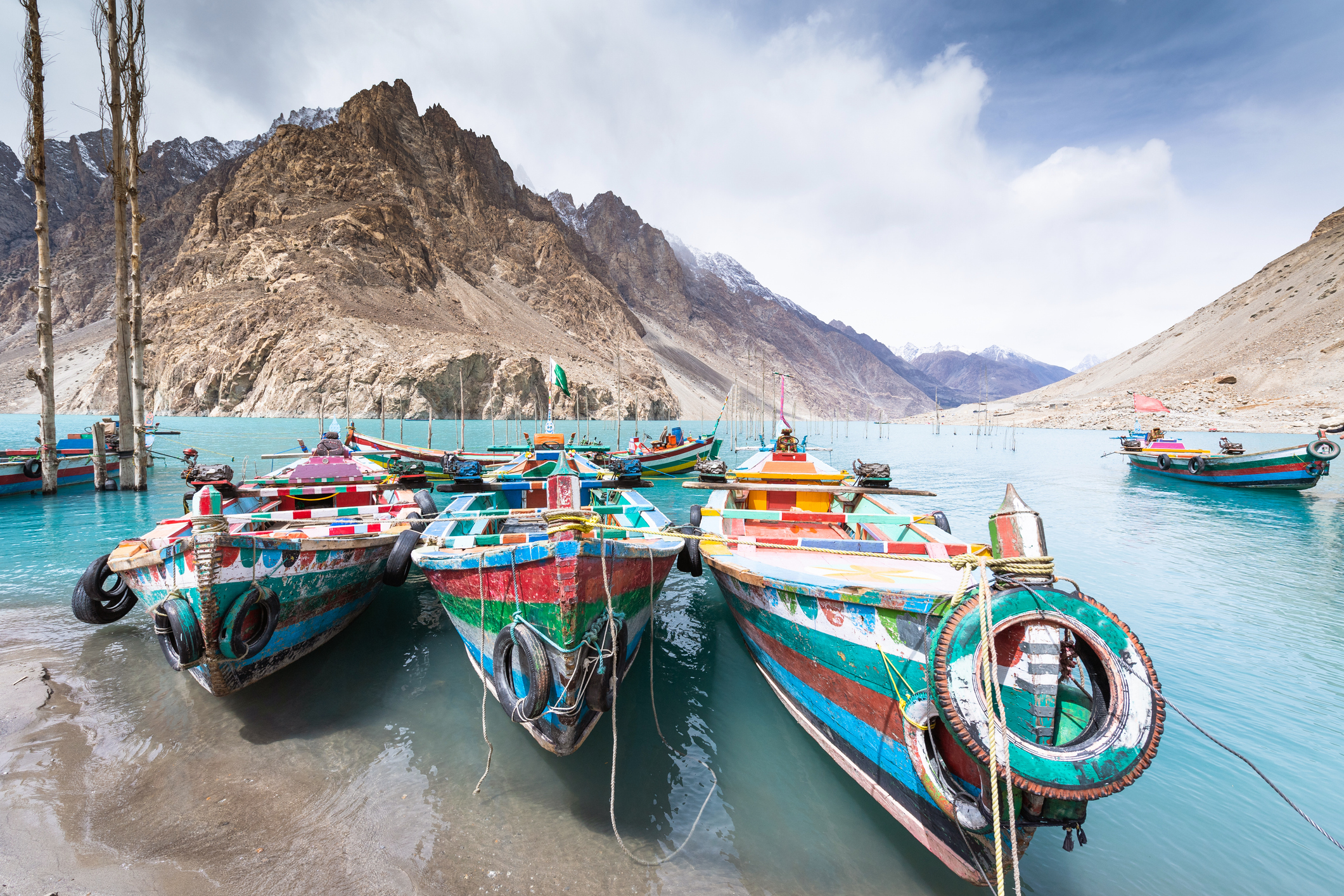 Local gondola boat wooden with Natural view along Attabad lake in Pakistan mountains at Hunza valley